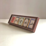 Angled front view of framed Chinese calligraphy desk decor with colorful silk fabric matting.