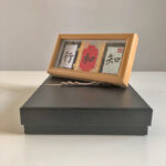 Handwritten Zhi He Xing 3-panel Song Brocade calligraphy wooden frame displayed on top of elegant black gift box